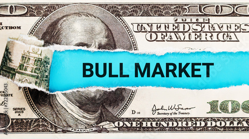 Bull Market. The word Bull Market in the background of the US dollar. Optimism, Investment Growth, and Positive Market Sentiment Concept.
