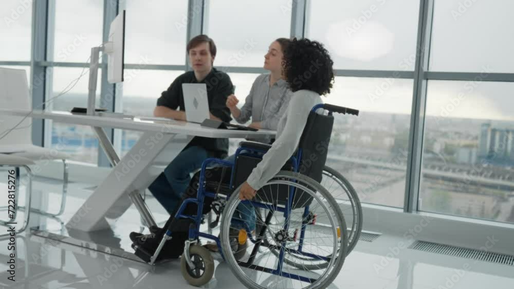 African american girl in wheelchair on job interview in business office. Human resources workers man woman interviewing candidate to work. Usual life of special needs person, getting job concept. African american girl in wheelchair on job interview in business office. Human resources workers man woman interviewing candidate to work. Usual life of special needs person, getting job concept.