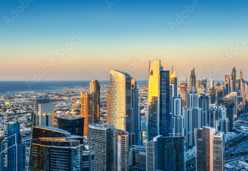 Modern city architecure at sunset. Elevated view of Dubai's business bay towers.