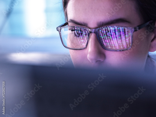 Young scientist examining DNA data on computer photo