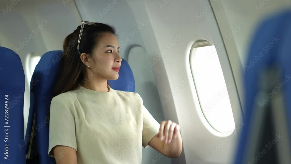 Young woman, businesswoman closing window during flight on plane. Young woman, businesswoman closing window during flight on plane.
