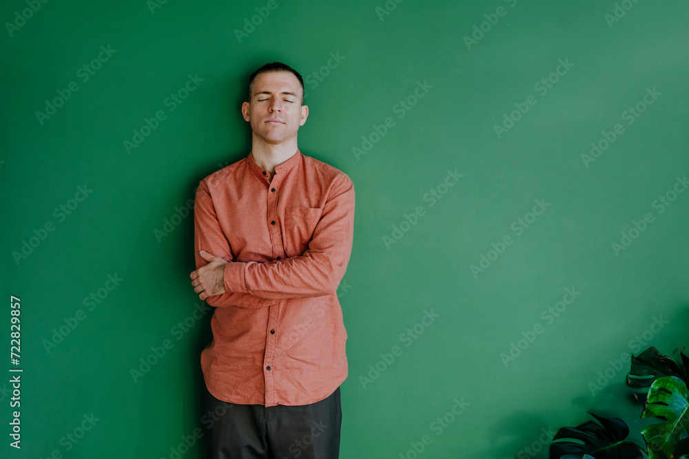 Man with eyes closed leaning on wall Man with eyes closed leaning on wall