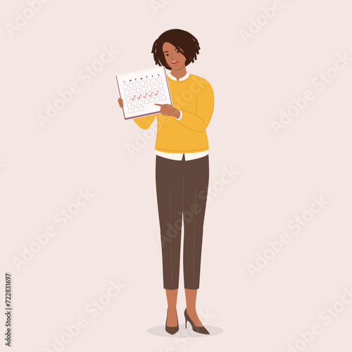One Smiling Black Businesswoman Standing And Displaying A Monthly Calendar With Checkmark. Full Length.