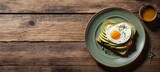 Avocado toast with fried egg on wooden background. Top view. Copy space