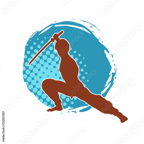 Silhouette of a kungfu or wushu martial art athlete in action pose. Silhouette of a male martial art person in pose with swords weapon.