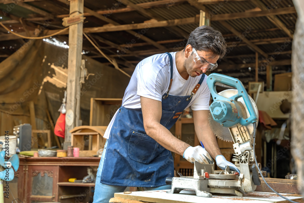 Handsome Caucasian carpenter man working with tool in carpentry woodworking workshop Handsome Caucasian carpenter man working with tool in carpentry woodworking workshop