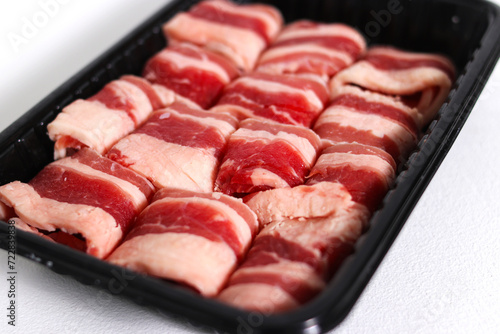 Sliced raw beef isolated on a white background photo