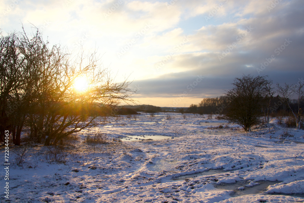 Sunset in snowy landscape on a cold winter day