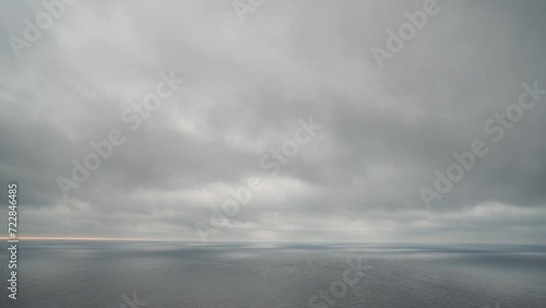 Timelapse rainy Nimbostratus clouds moving in bright sunset sky over stormy sea. Abstract aerial nature summer ocean sunset, sea and sky view. Vacation, travel concept. Weather and Climate Change photo