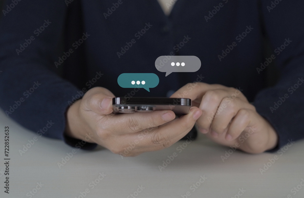 Women hand using smartphone typing Live chat chatting and social network concepts, chatting conversation working at home in chat box icons pop up. Social media marketing technology concept. Women hand using smartphone typing Live chat chatting and social network concepts, chatting conversation working at home in chat box icons pop up. Social media marketing technology concept.