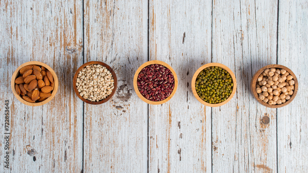 Mung beans, Red kidney beans, Chickpeas source and peeled barley in a basket wooden isolated on wood background