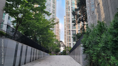 A newly built Korean apartment building and a walking path inside the apartment building complex