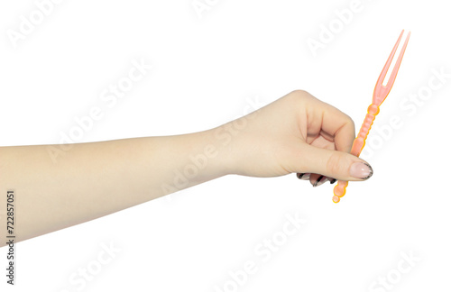 skewer for appetizer in hand, outstretched hand with plastic skewer for canapes isolated from background
