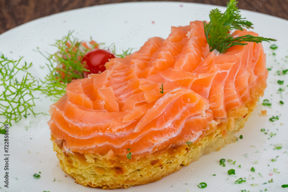 fish sandwich. a hearty sandwich with slices of red salmon, parsley and dill on top, snack concept fish sandwich. a hearty sandwich with slices of red salmon, parsley and dill on top, snack concept