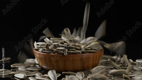 black sunflower seeds falling on table. photo