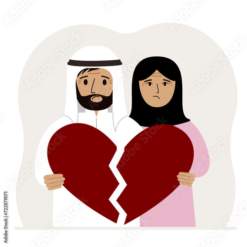 A sad man and woman are holding pieces of a broken red heart in their hands. Broken heart.