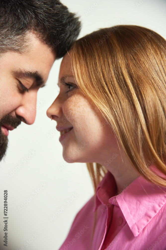 Naklejka premium Close up photo of man and woman, wife and husband lovely looking to each other against white background. Romantic in relationship. Concept of love, Valentine Day, togetherness. Ad
