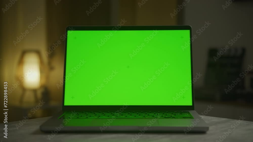 Laptop with Green Screen Chroma Key Screen on Desk at Night Laptop with Green Screen Chroma Key Screen on Desk at Night
