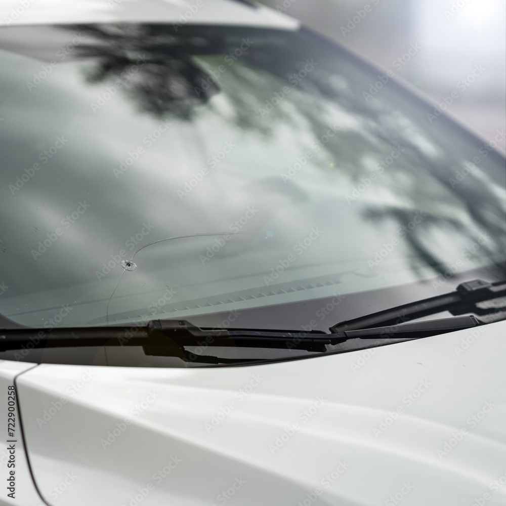 window broken by a stone in the car - insurance - road accident - broken glass