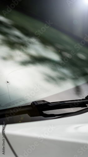 Obraz na płótnie detail of a broken window by a stone in a car on the highway - the cost of replacing the windshield w salonie