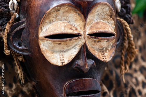 Wooden tribal African mask from Uganda, for family or personal protection, made of local wood, ropes and seashells as hair decoration