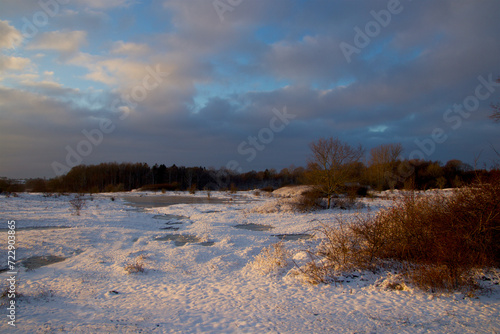 Threatening sky in snowy landscape on the cold meadow © tiger2506