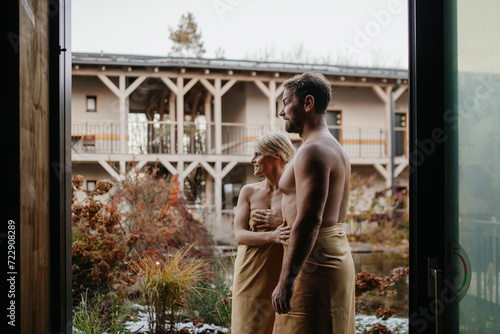 Beautiful couple standing in hotel wellness, enjoying romantic weekend in spa. Concept of Valentine's Day.