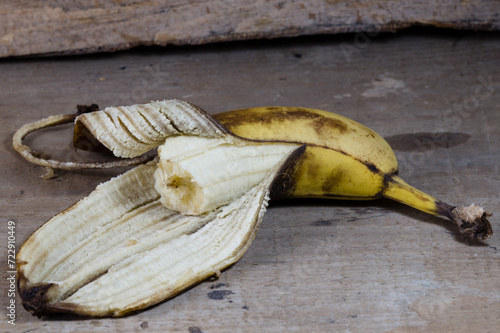 Wallpaper Mural bitten banana on the table Torontodigital.ca