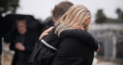 Sad, death and a girl with her father at a funeral for grief or mourning loss together outdoor. Family, empathy and a man holding his daughter at a memorial service or ceremony for condolences © CineLens/peopleimages.com