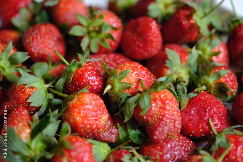a pile of fresh strawberries. Strawberry is a fruit that contains antioxidants and vitamin C. a pile of fresh strawberries. Strawberry is a fruit that contains antioxidants and vitamin C.
