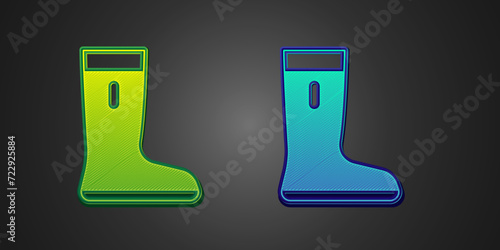 Green and blue Waterproof rubber boot icon isolated on black background. Gumboots for rainy weather, fishing, gardening. Vector