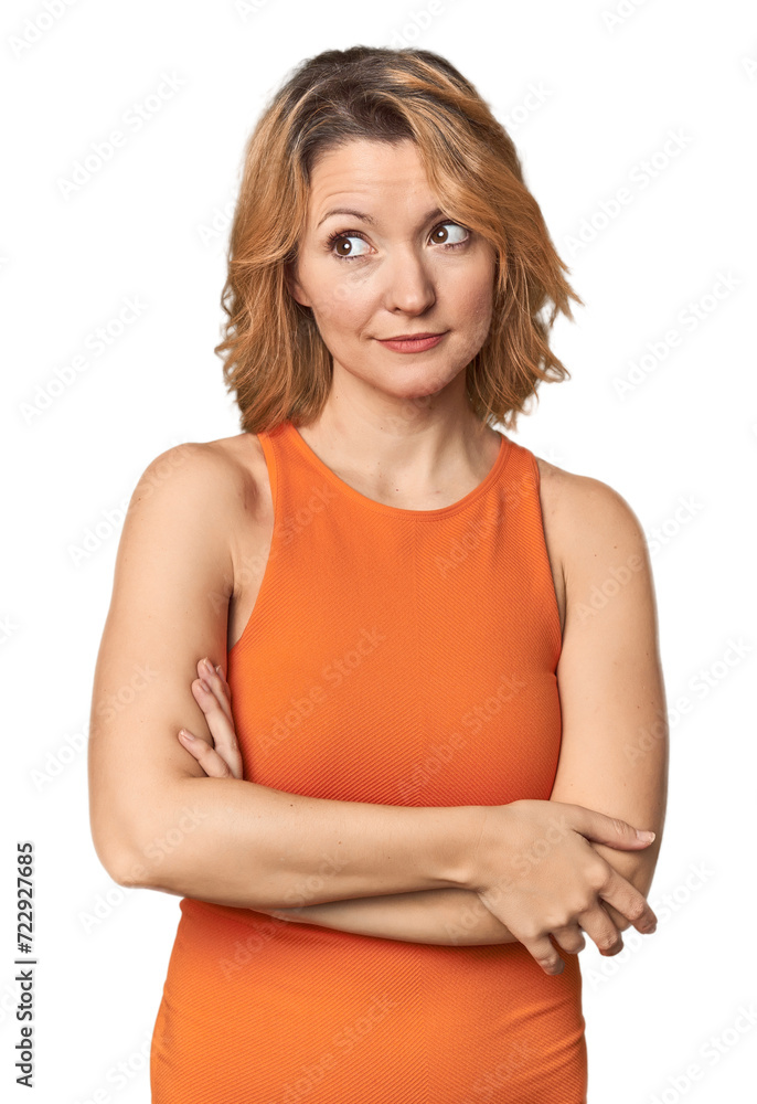 Blonde middle-aged Caucasian woman in studio dreaming of achieving goals and purposes Blonde middle-aged Caucasian woman in studio dreaming of achieving goals and purposes
