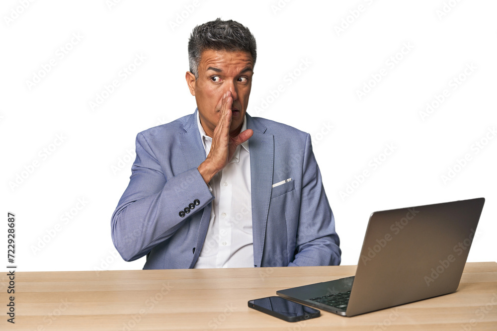 Elegant businessman at desk with laptop is saying a secret hot braking news and looking aside Elegant businessman at desk with laptop is saying a secret hot braking news and looking aside