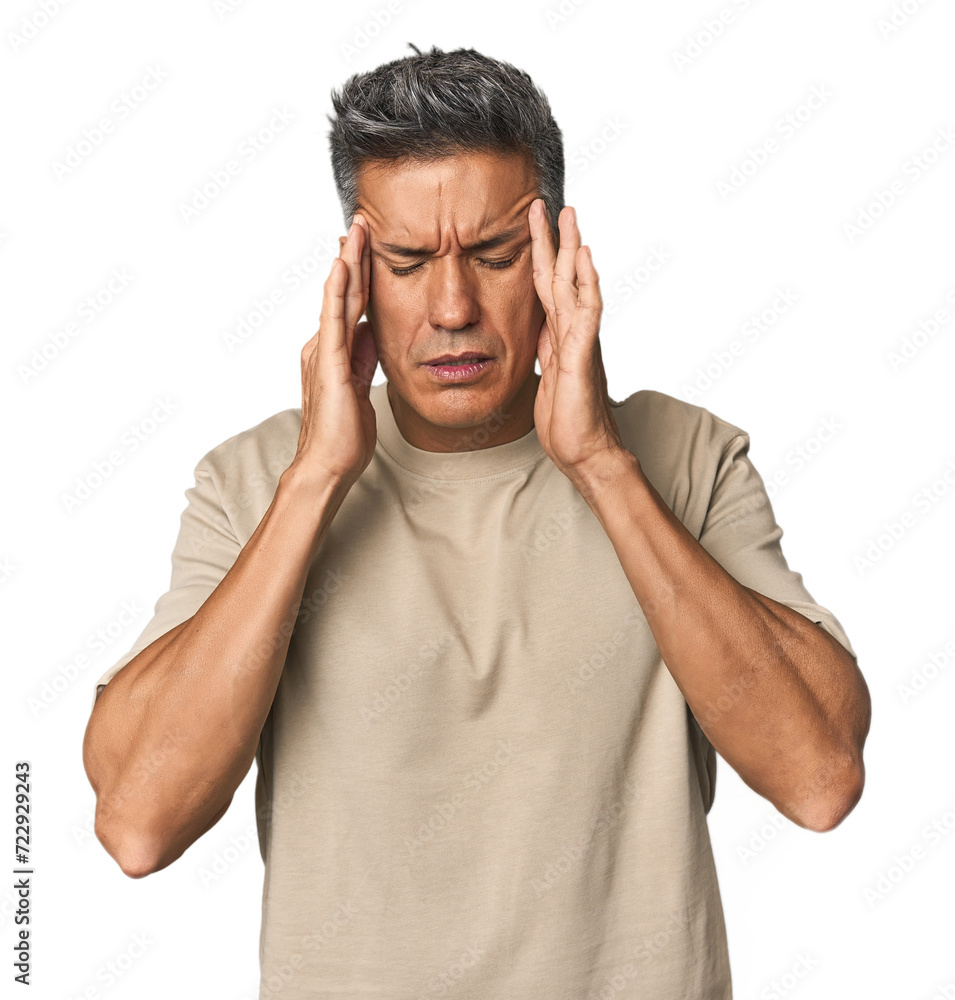 Middle-aged Latino man touching temples and having headache. Middle-aged Latino man touching temples and having headache.