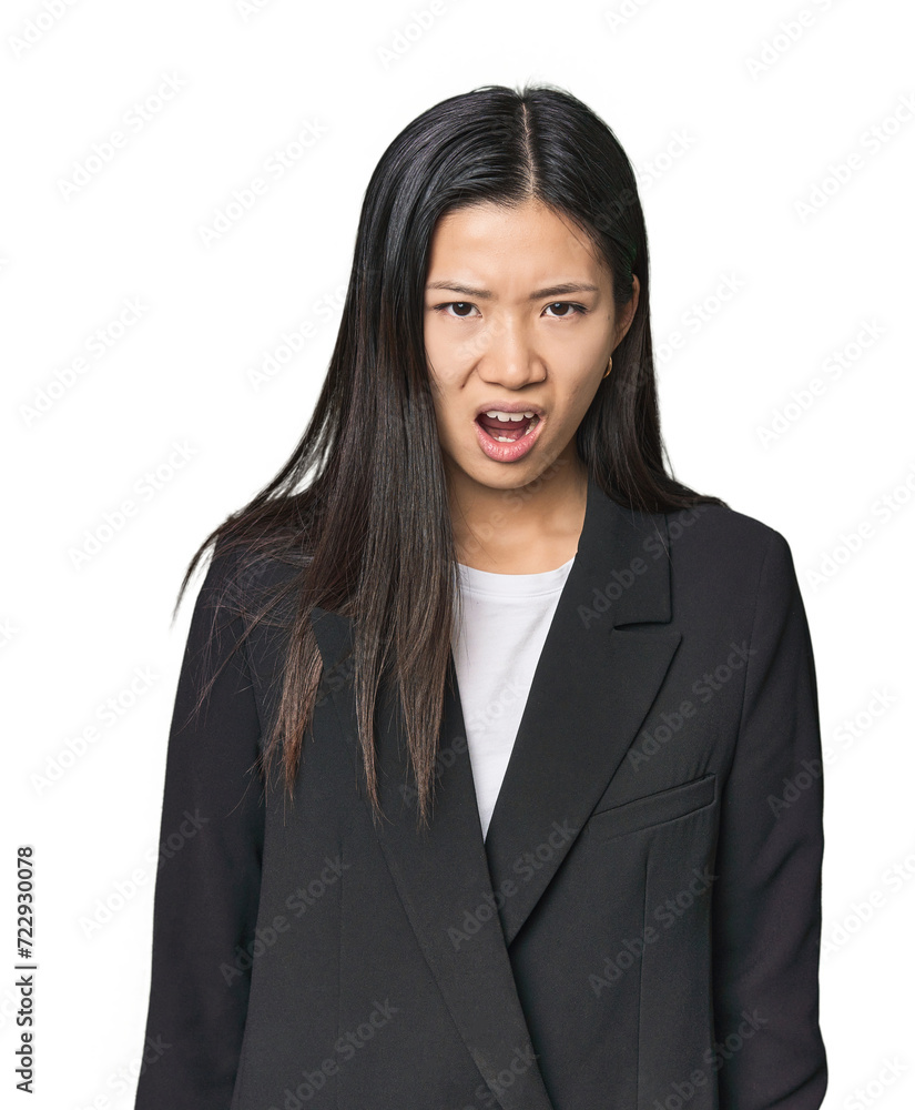 Young Chinese woman in business suit screaming very angry and aggressive. Young Chinese woman in business suit screaming very angry and aggressive.