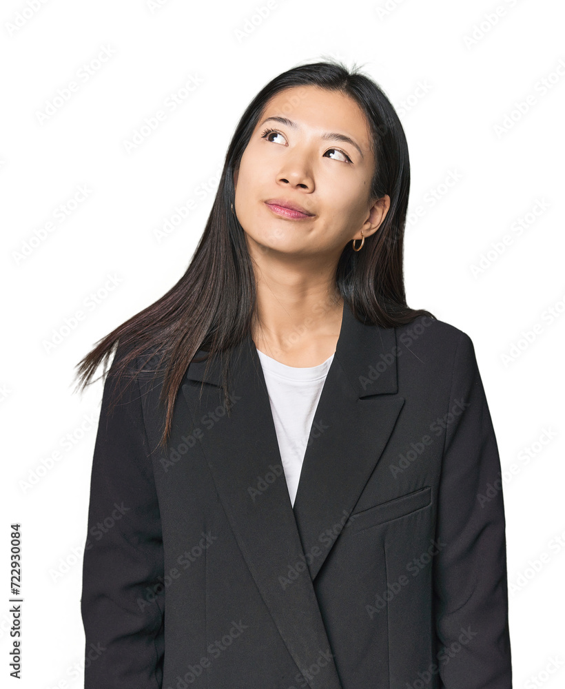 Young Chinese woman in business suit dreaming of achieving goals and purposes Young Chinese woman in business suit dreaming of achieving goals and purposes