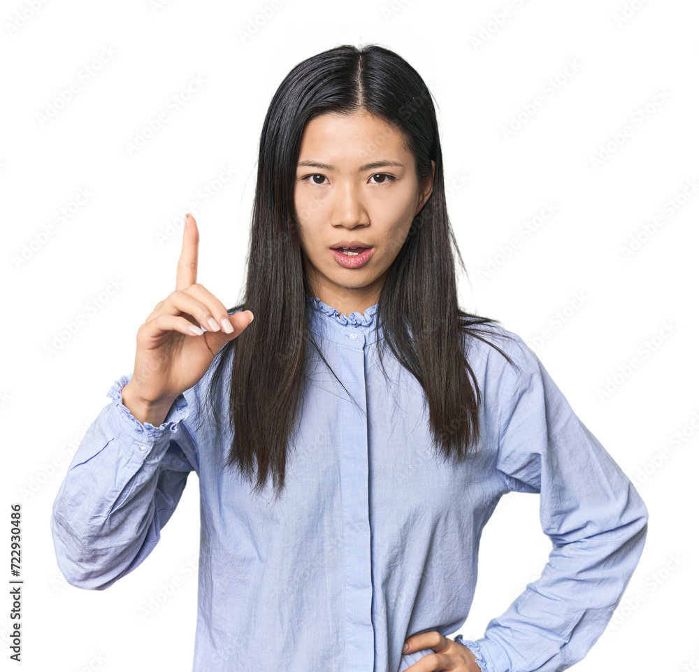 Young Chinese woman in blue shirt having an idea, inspiration concept. Young Chinese woman in blue shirt having an idea, inspiration concept.