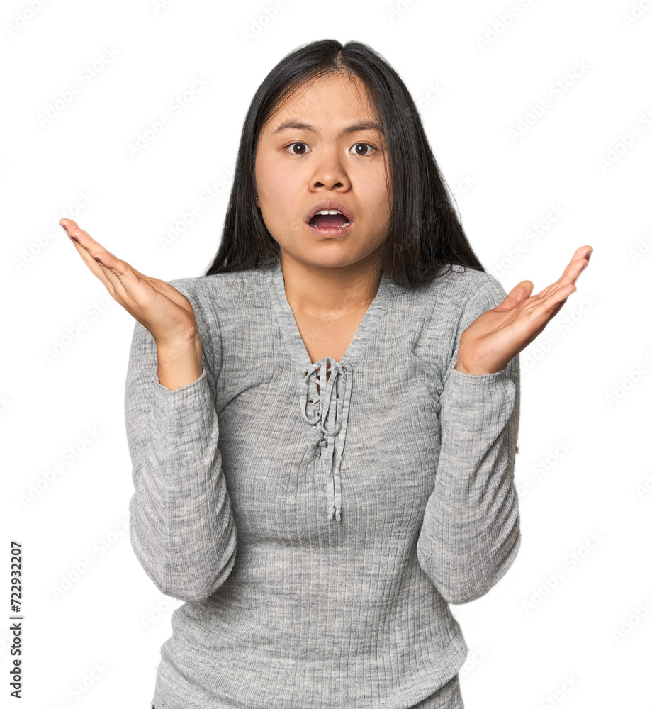 Young chinese woman isolated surprised and shocked. Young chinese woman isolated surprised and shocked.