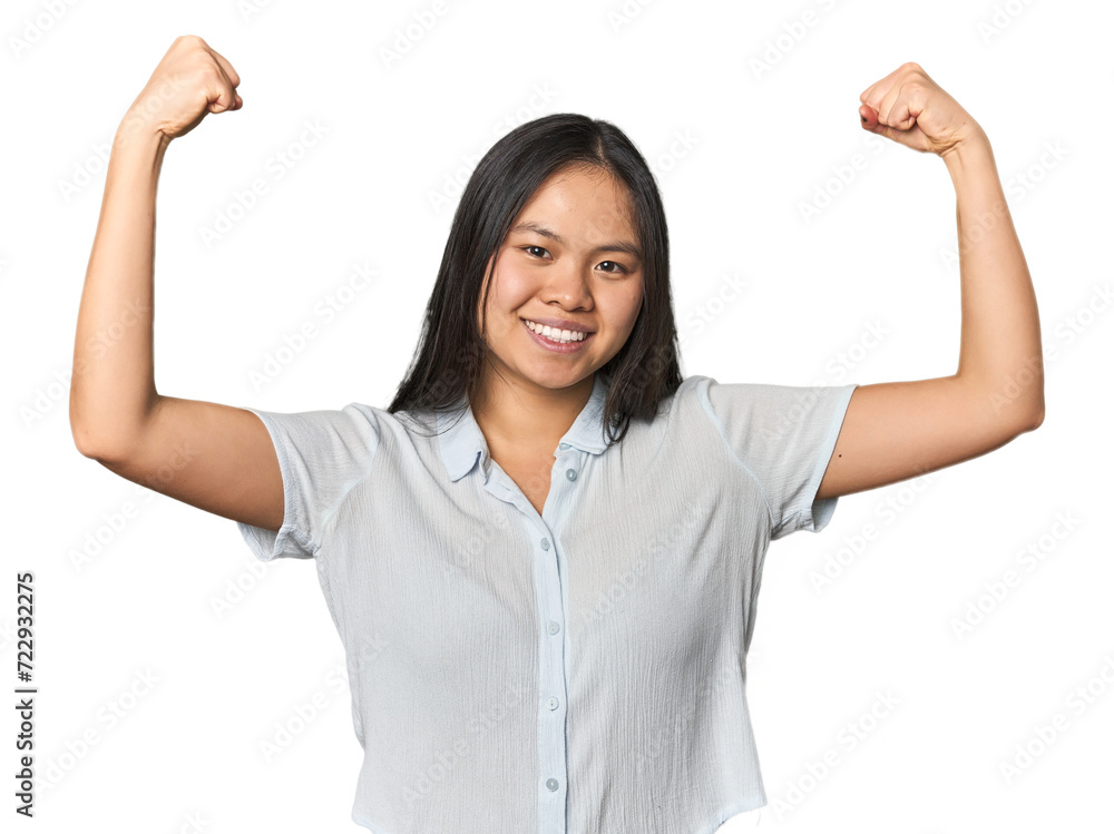Young chinese woman isolated showing strength gesture with arms, symbol of feminine power Young chinese woman isolated showing strength gesture with arms, symbol of feminine power