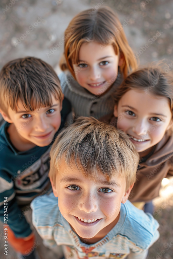 A Playful Aerial View of a Group of Kids Gazing Up at the Camera with Innocent Smiles A Playful Aerial View of a Group of Kids Gazing Up at the Camera with Innocent Smiles