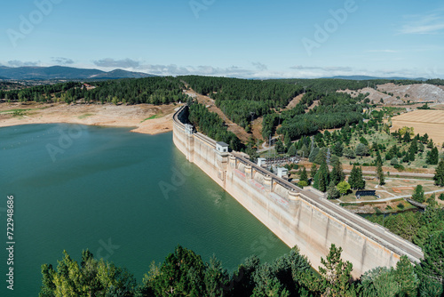 Hydroelectric dam with low water level in summer. Aguilar de Campoo, Spain photo
