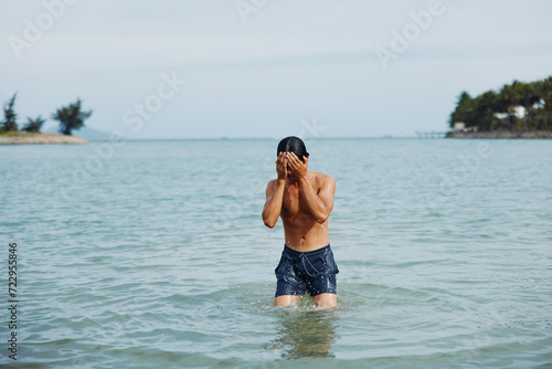 Active Asian Man Enjoying Water Sport and Relaxation at Tropical Beach