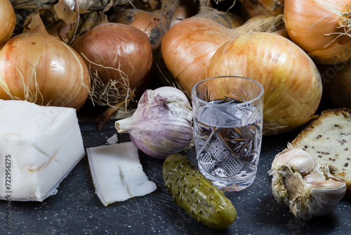 glass with alcohol, lard, garlic, onion