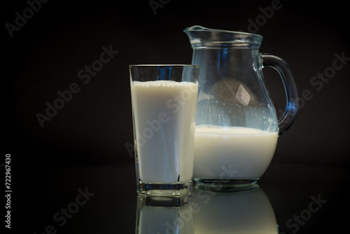 fresh natural milk in a glass and in a glass decanter