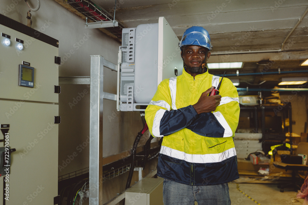 engineering technician Setting up the solar panel inverter in the electrical room Service engineer installs solar cells on factory roofs Concept of clean energy and renewable energy engineering technician Setting up the solar panel inverter in the electrical room Service engineer installs solar cells on factory roofs Concept of clean energy and renewable energy
