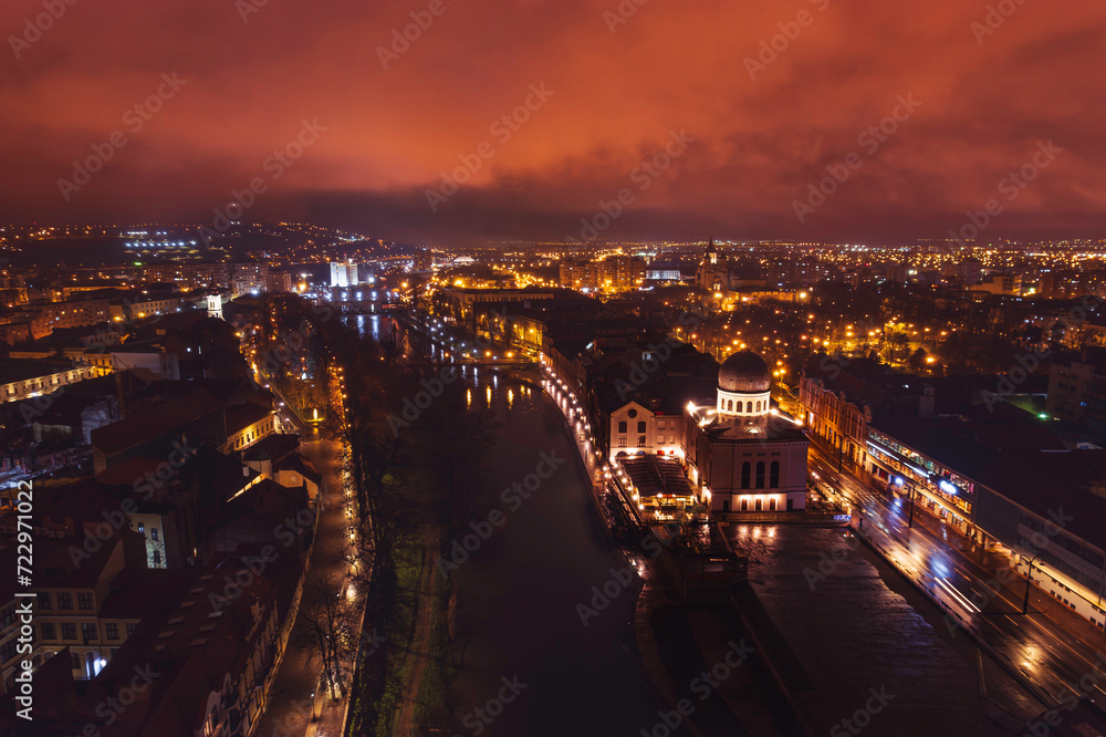 Luminescent Tapestry: Captivating Aerial View of Oradeas Vibrant Night Cityscape