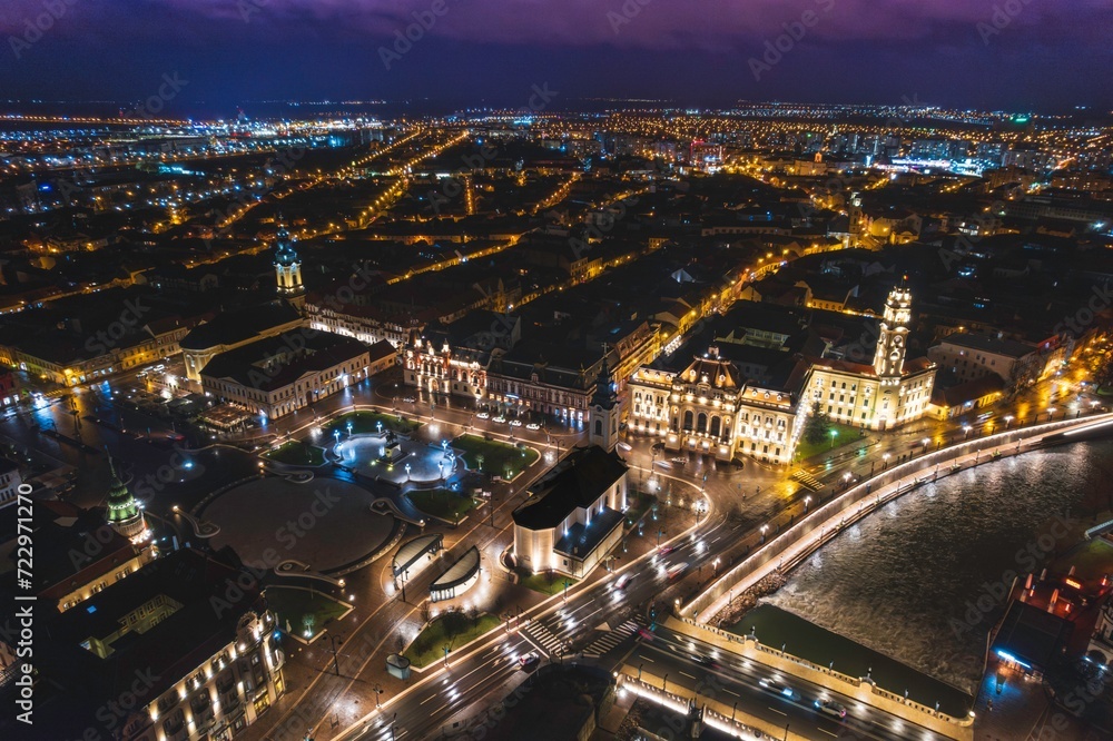 Obraz premium Glimmers of Life: Captivating Nighttime Aerial View of Oradea, Romanias Vibrant Cityscape