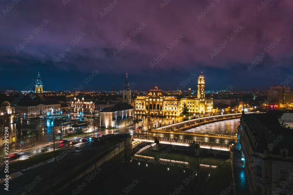 Obraz premium Midnight Serenade: Illuminated City Rhapsody, A Breathtaking Aerial View of Oradeas Stunning Bridge-lit Skyline