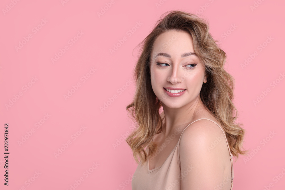 Portrait of smiling woman on pink background. Space for text Portrait of smiling woman on pink background. Space for text