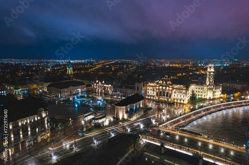 Luminous Tapestry: A Mesmeric Aerial Glimpse of Oradea, Romanias Bustling Nighttime Cityscape